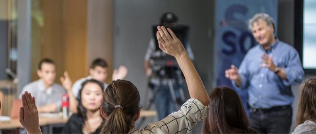 School of Communication at °ϲ University (student raising her hand in class)