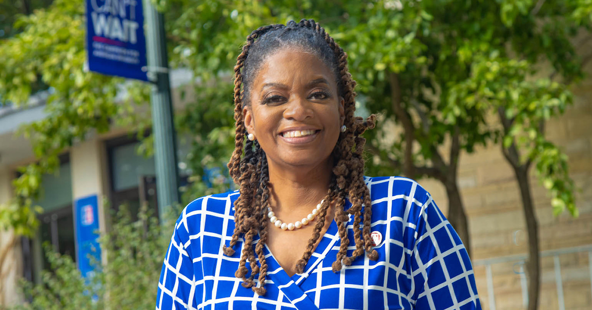 LaTanya Sothern, °ϲ University's new Alumni Association President, poses on campus. She smiles and wears blue and white—two of the university's colors.