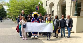 Participants in Bring Your Child to Work Day pose with Clawed Z. Eagle in front of Mary Graydon Center. Photo by Andie Rowe.