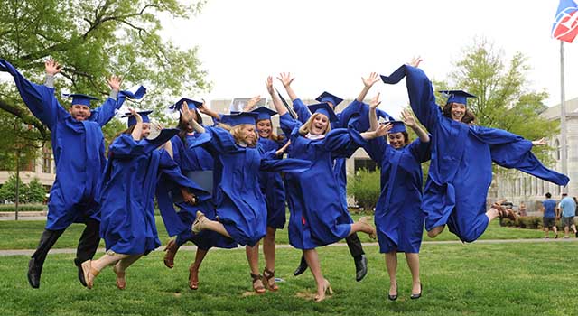 °ϲ University graduates leap in celebration on the Quad