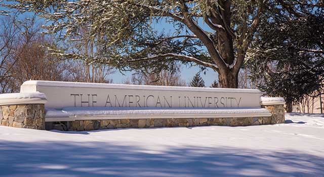 The °ϲ University gate covered in snow.